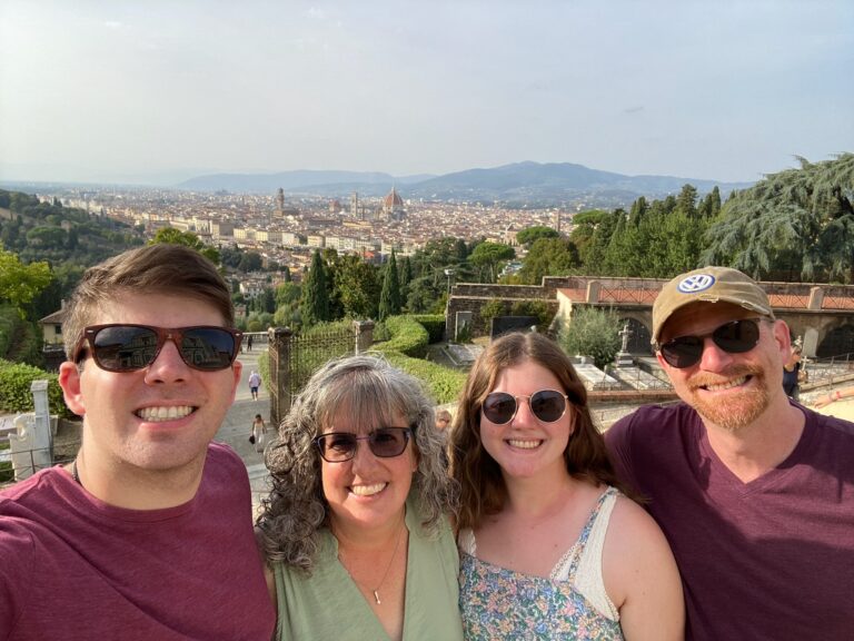 A group of people standing in front of a city.