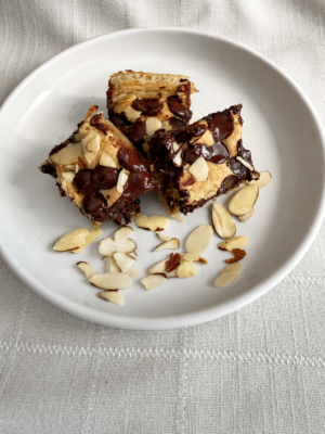 Chocolate Almond Croissant Bar topped with dark chocolate and sliced almonds