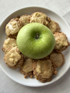 Apple Orchard Cookies with caramel frosting arranged around a green apple